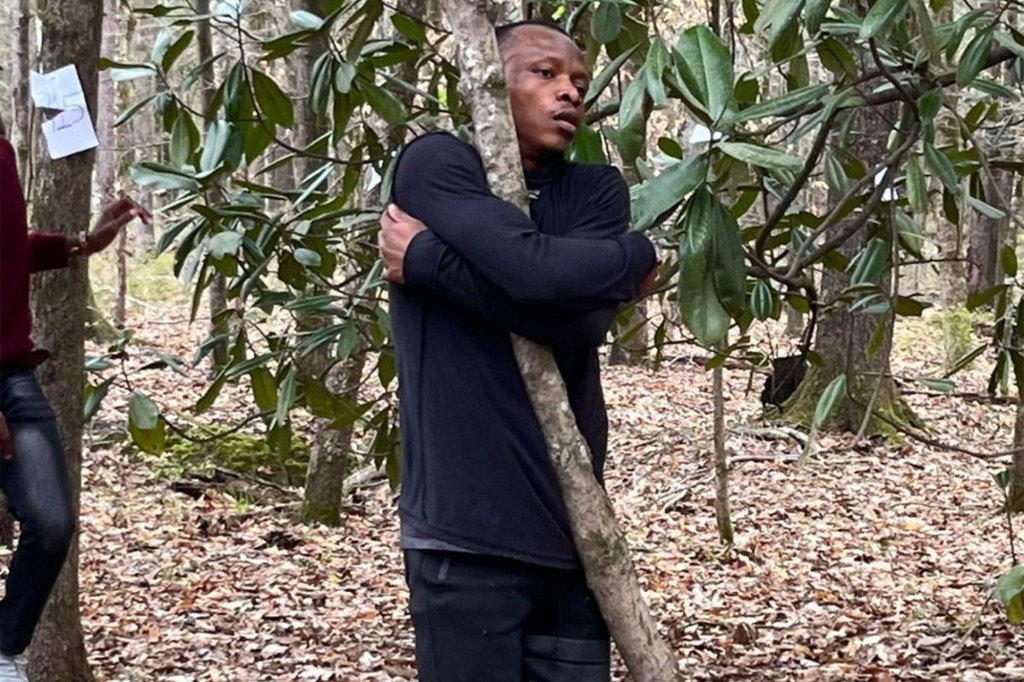 Abubakar Tahiru hugging a tree.