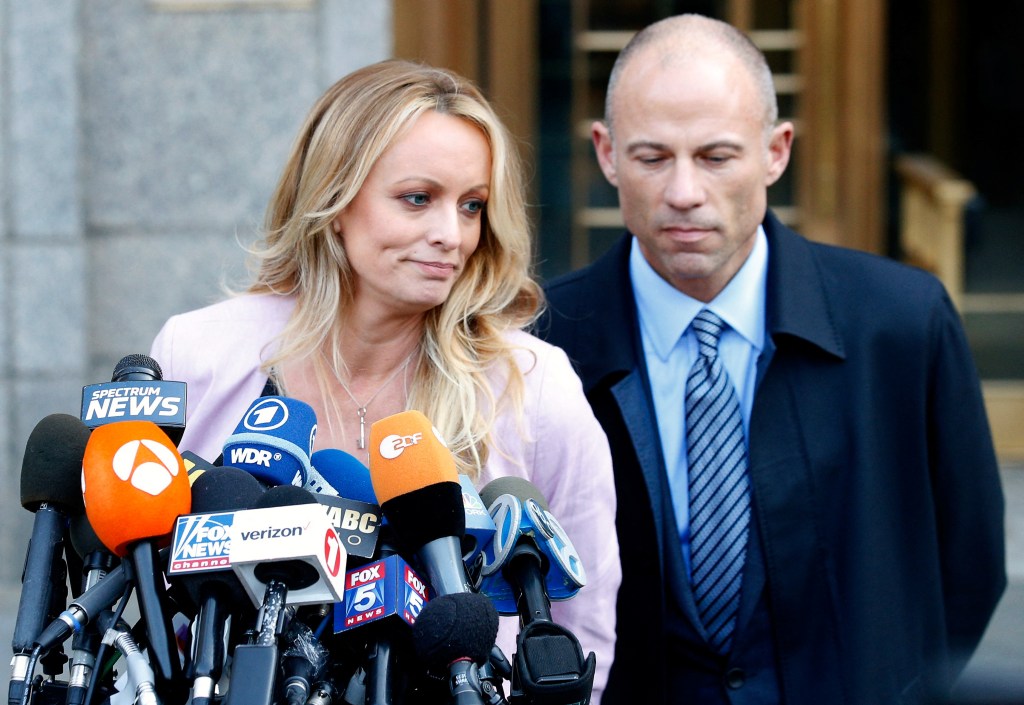 Adult film actress, Stormy Daniels, speaking to the media in front of a lot of news microphones with her lawyer, Michael Avenatti, outside federal court in Manhattan