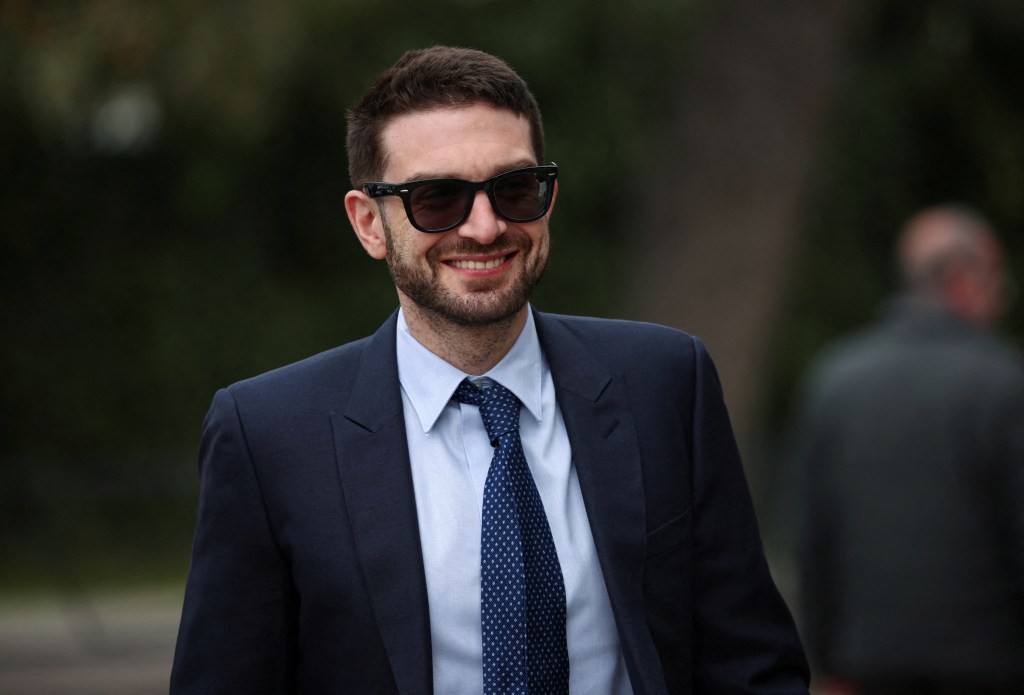 Alexander Soros in a suit and tie walking at the venue during the EU-Western Balkans summit in Tirana, Albania on February 29, 2024.