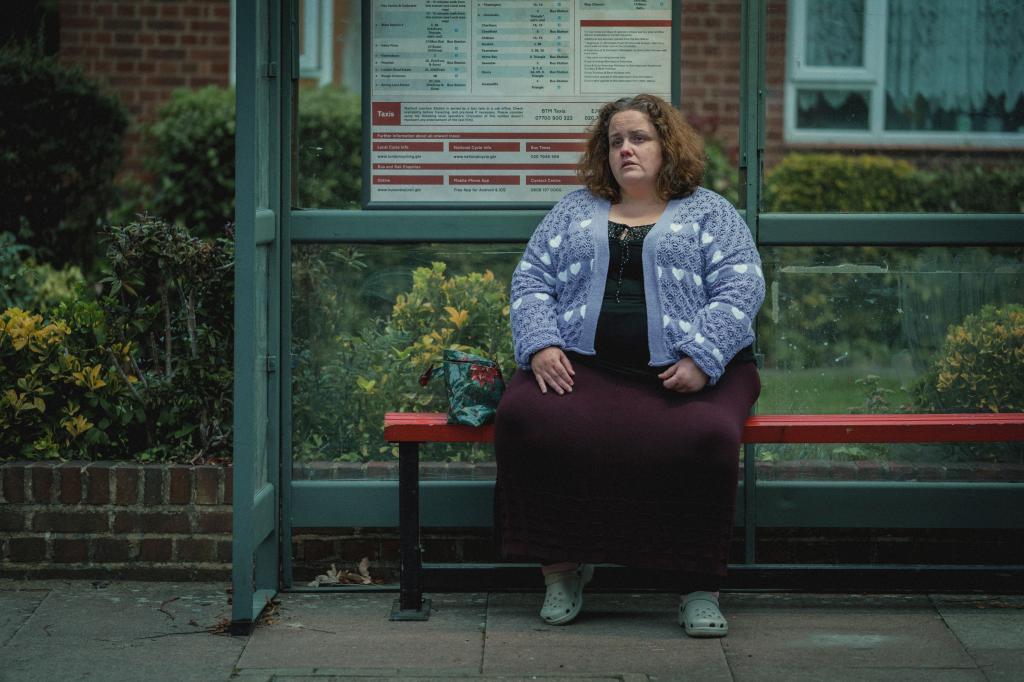 Jessica Gunning sitting on a bench. 