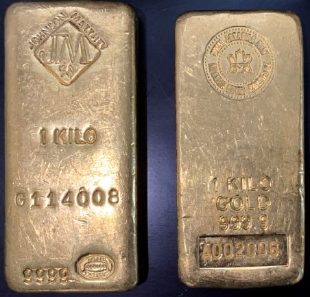 Two gold bars marked (left) 1 kilo, G114008, and (right) 1 kilo gold 9999