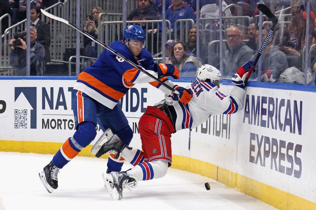 Noah Dobson #8 of the New York Islanders checks Vincent Trocheck #16 of the New York Rangers in the final minute of play of the third period at UBS Arena on April 09, 2024 in Elmont, New York. The Islanders defeated the Rangers 4-2. 