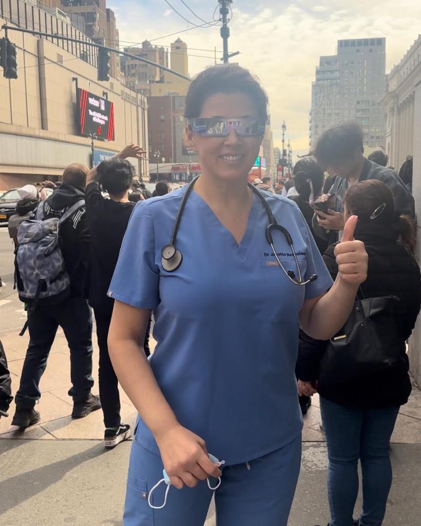 Dr. Janette Nesheiwat, a New York City-based double board-certified doctor, wearing blue scrubs and a stethoscope around her neck