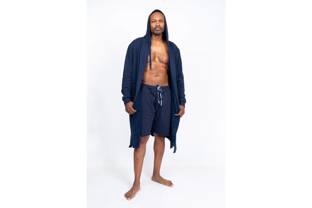 A man wearing a blue robe and shorts