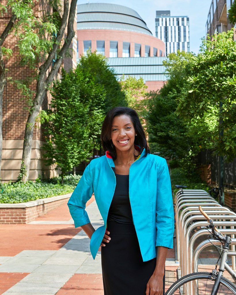 Erika James, dean of the Wharton School, standing in front of a bicycle rack