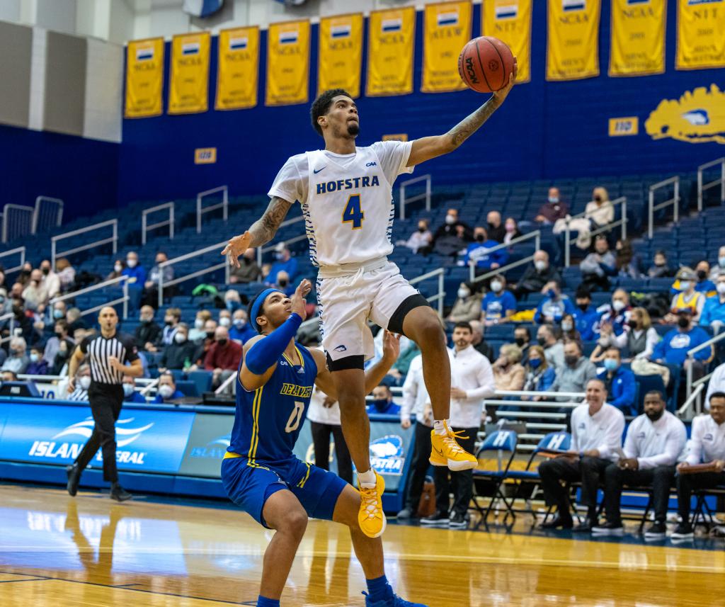 Pride guard Aaron Estrada (4) goes to the hoop past Delaware Fightin Blue Hens guard Jameer Nelson Jr. (0) during the Delaware Blue Hens at the Hofstra University Pride on January 15, 2022.