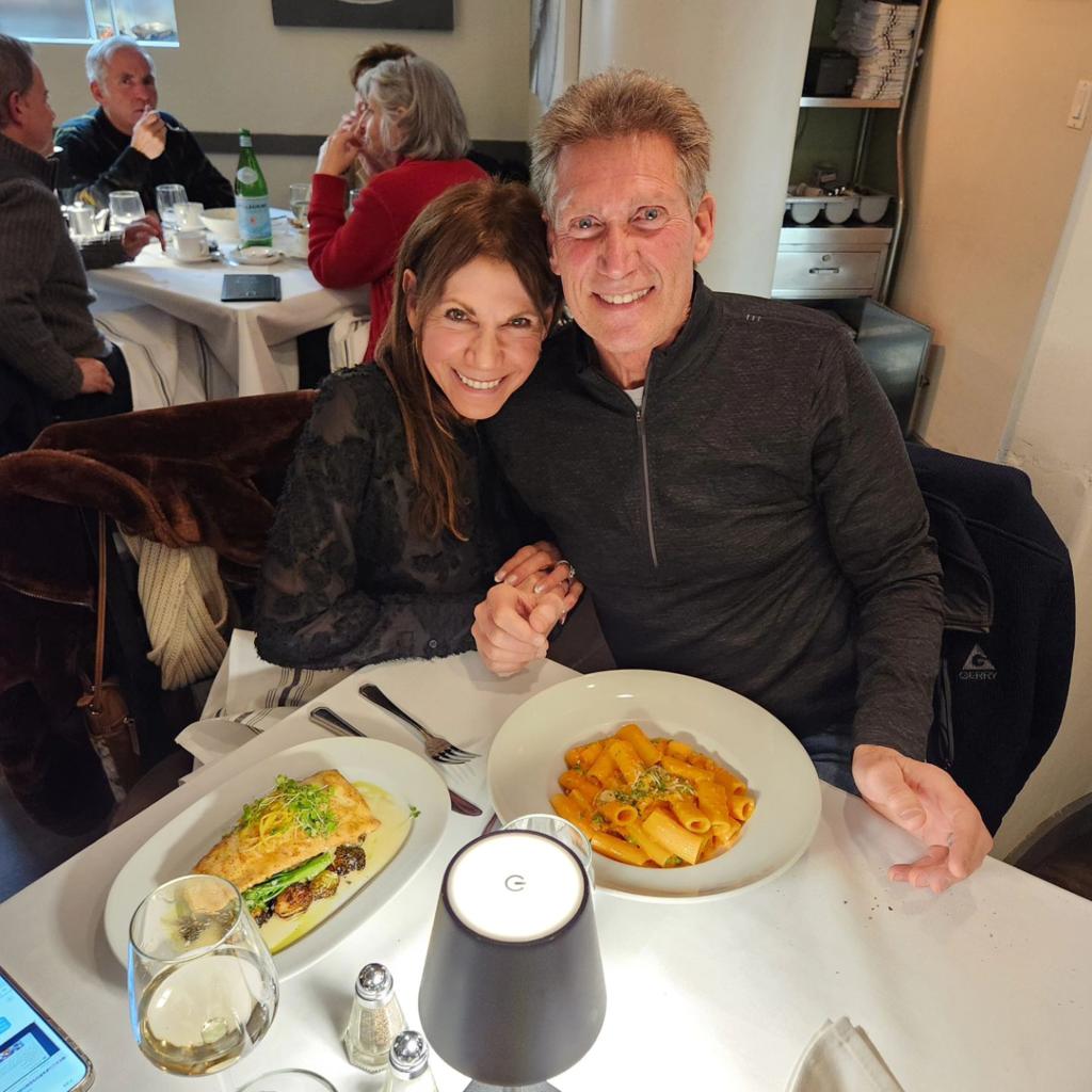 Reality stars Gerry Turner and Theresa Nist sitting at a table with food after their stint on the 'Golden Bachelor' show