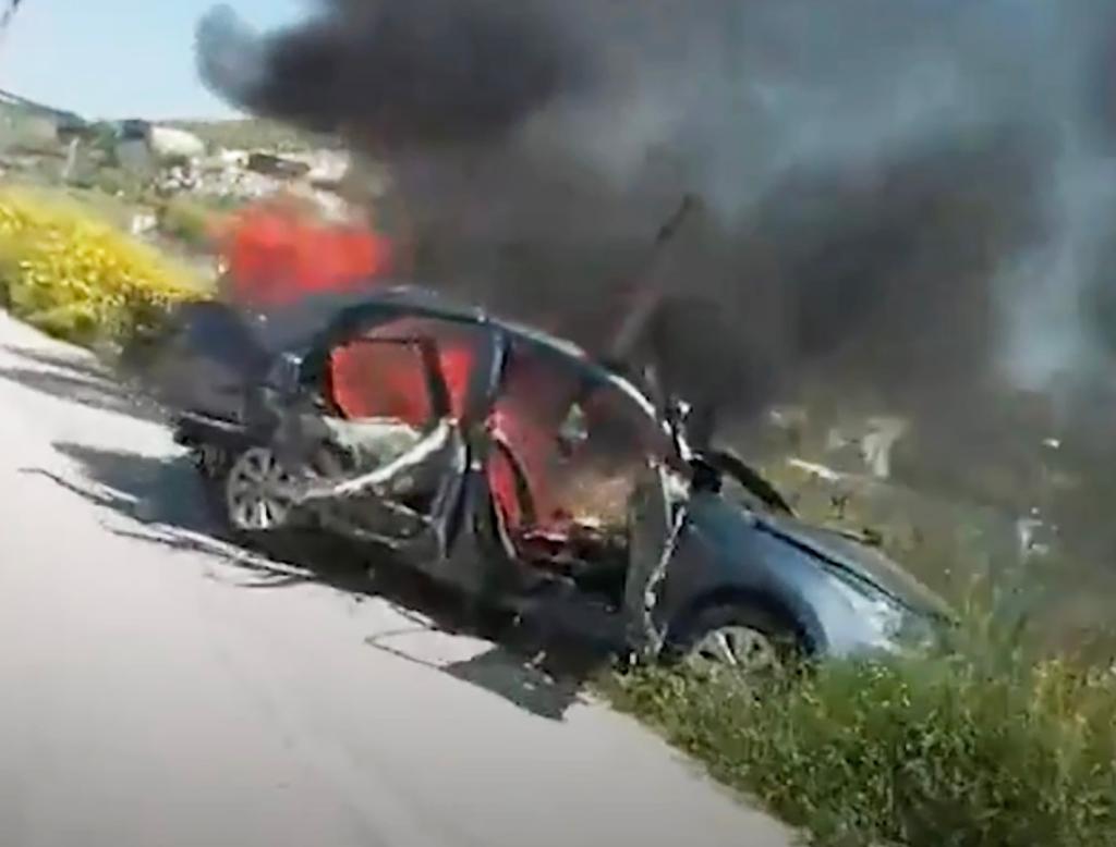 The wreckage of Baz's sedan seen engulfed in flames in Ain Baal, Lebanon, Tuesday. 