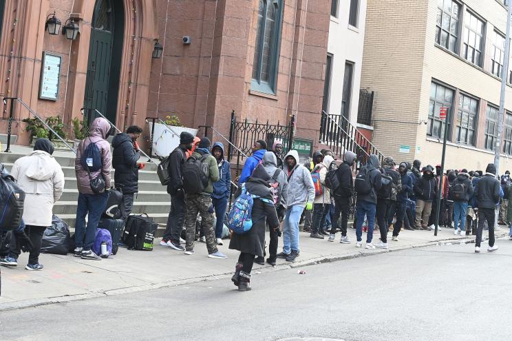 Hundreds of migrants lined up around the block outside St. Brigid Church on Avenue B and East 7th St. in the East Village.