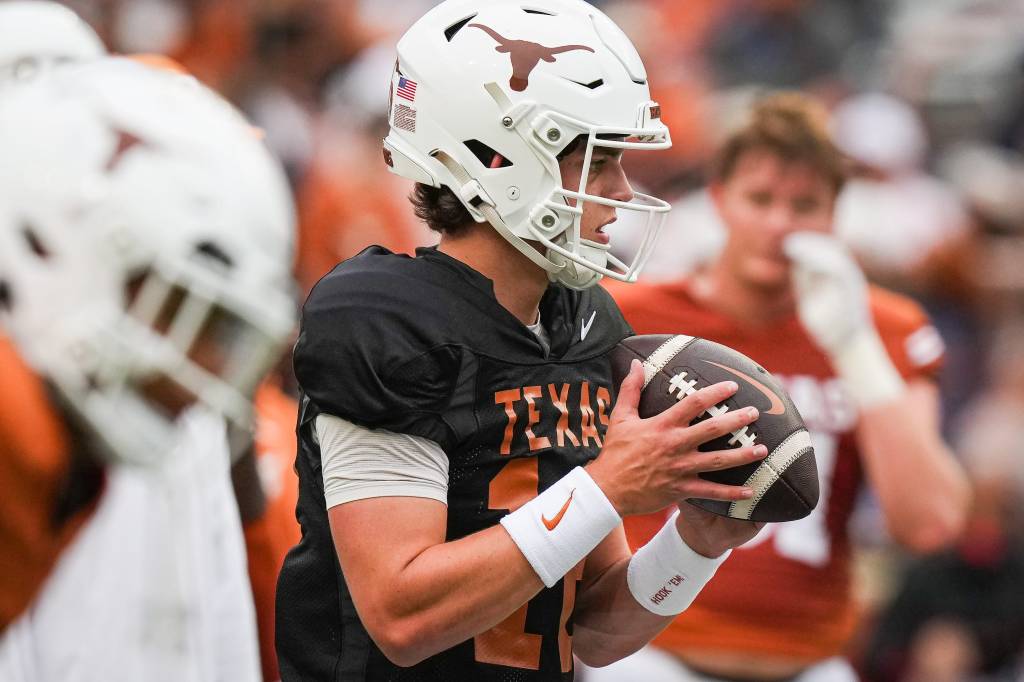 Arch Manning (16) looks for a pass while warming up ahead of the Longhorns' spring Orange and White game at Darrell K Royal Texas Memorial Stadium.