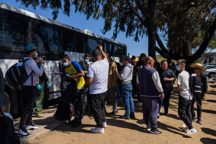 Migrants are dropped off by Border Patrol at the Iris Transit Center in San Diego, California.