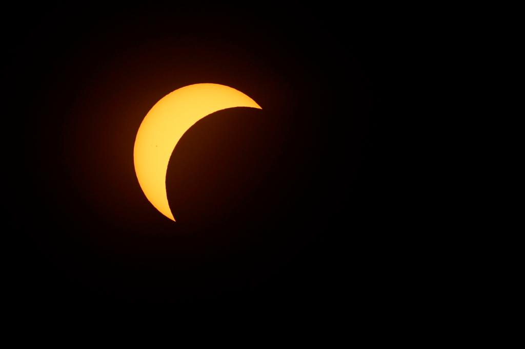 The moon partially covering the sun during the eclipse.