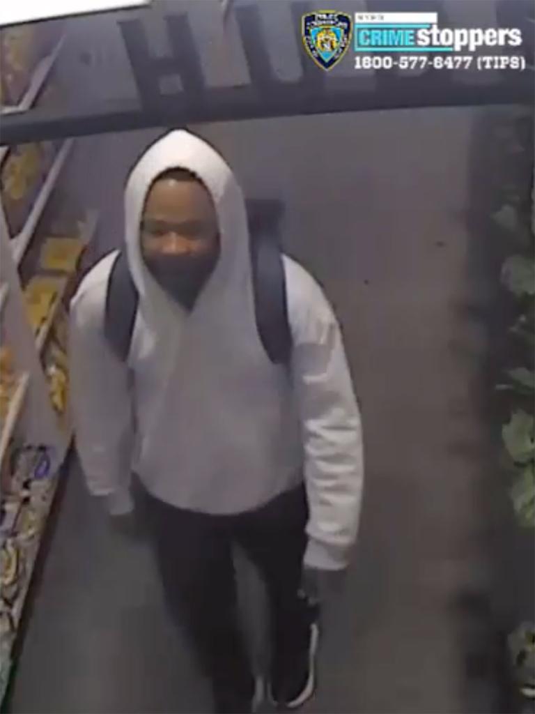 A photo of the suspect in the incident taken from a video shows the man wearing a gray hooded sweatshirt, black pants, black sneakers, and carry a dark colored bookbag.