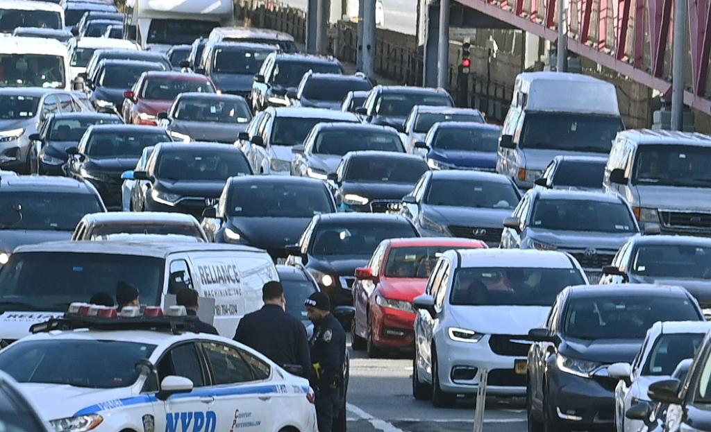 Heavy traffic congestion on Delancey St. in Lower East Side, Manhattan, illustrating the congestion pricing plan