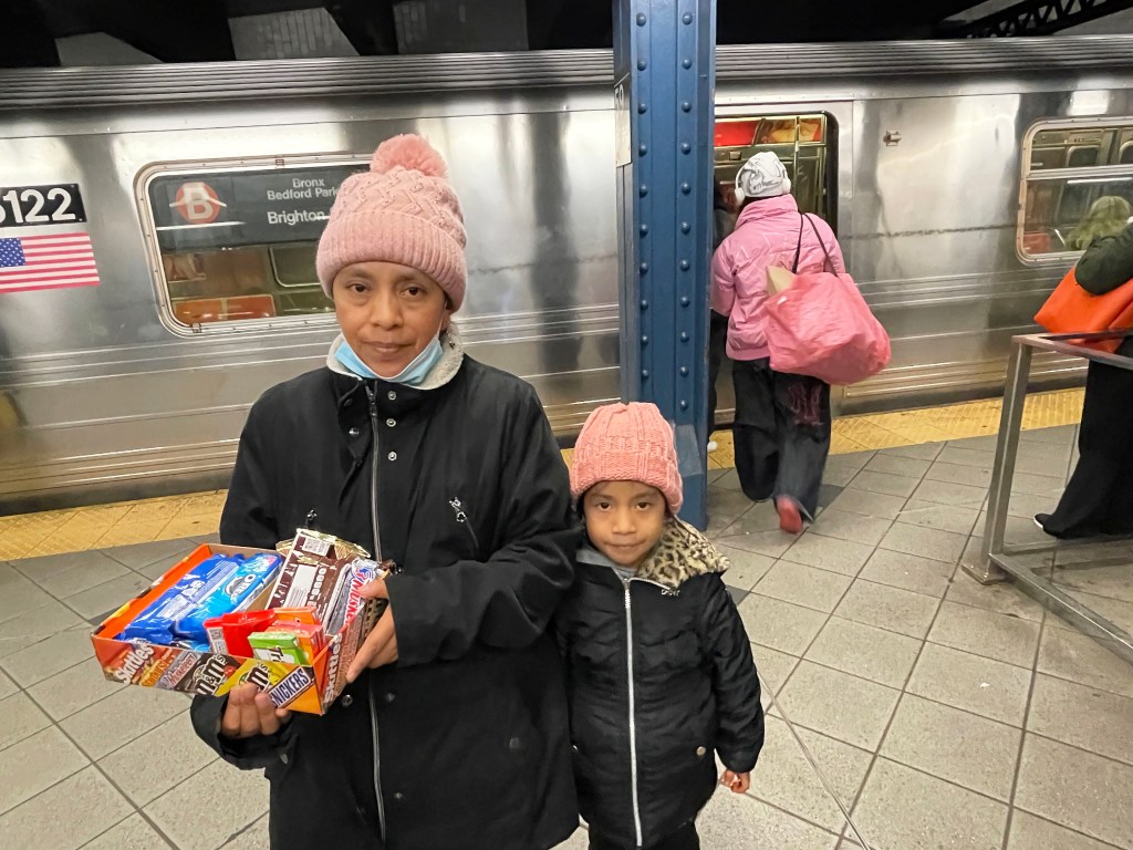 Migrant mom Maria and her daughter sell candy in the subways. 