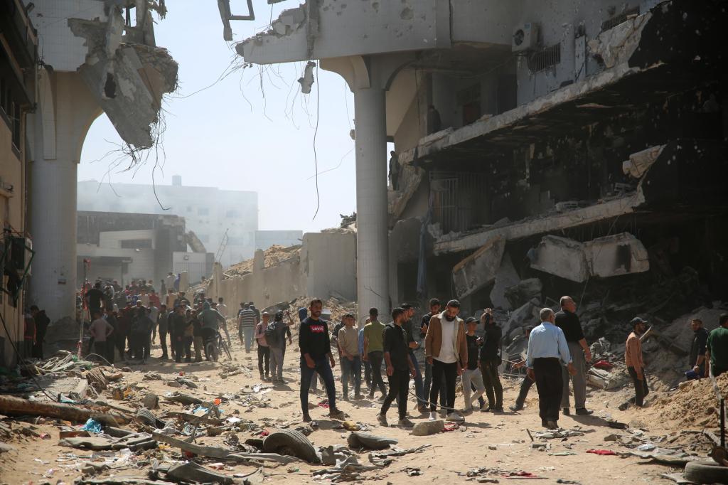 Palestinians inspect the damage in the area around Gaza's Al-Shifa hospital 