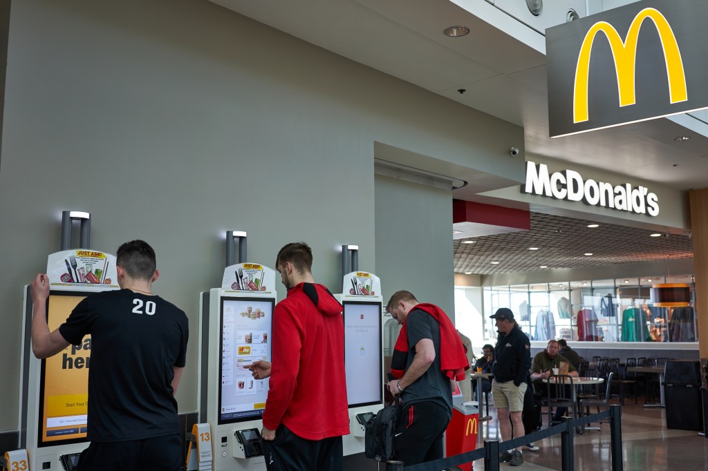 Flyers use the self-service kiosks to place their orders at a McDonald's at Portland International Airport in February 2020.