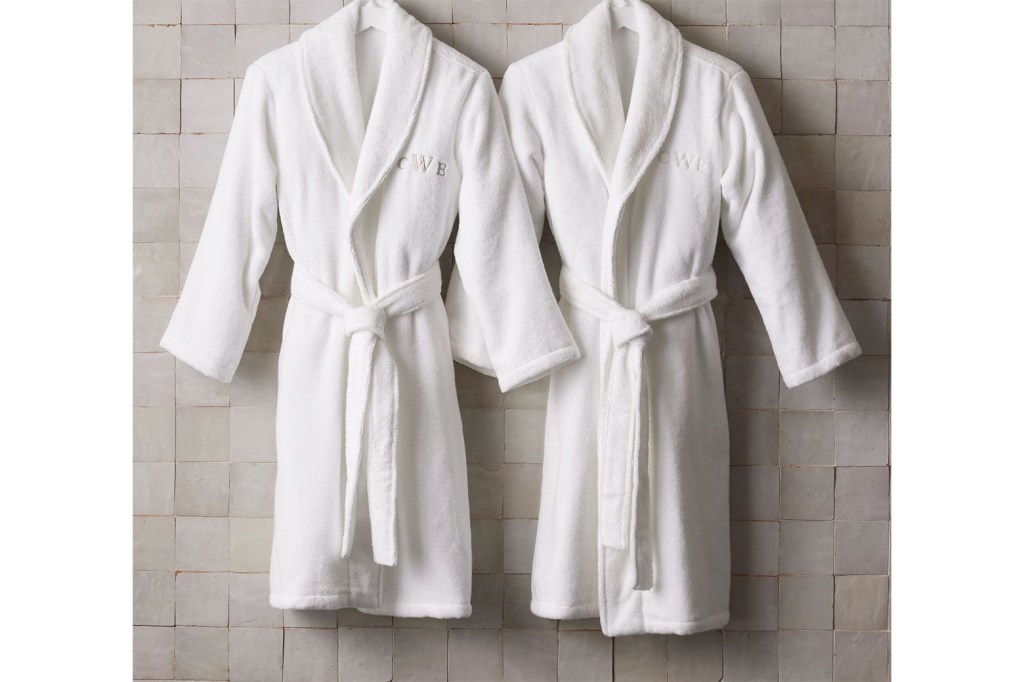 A couple of white robes hanging on a wall