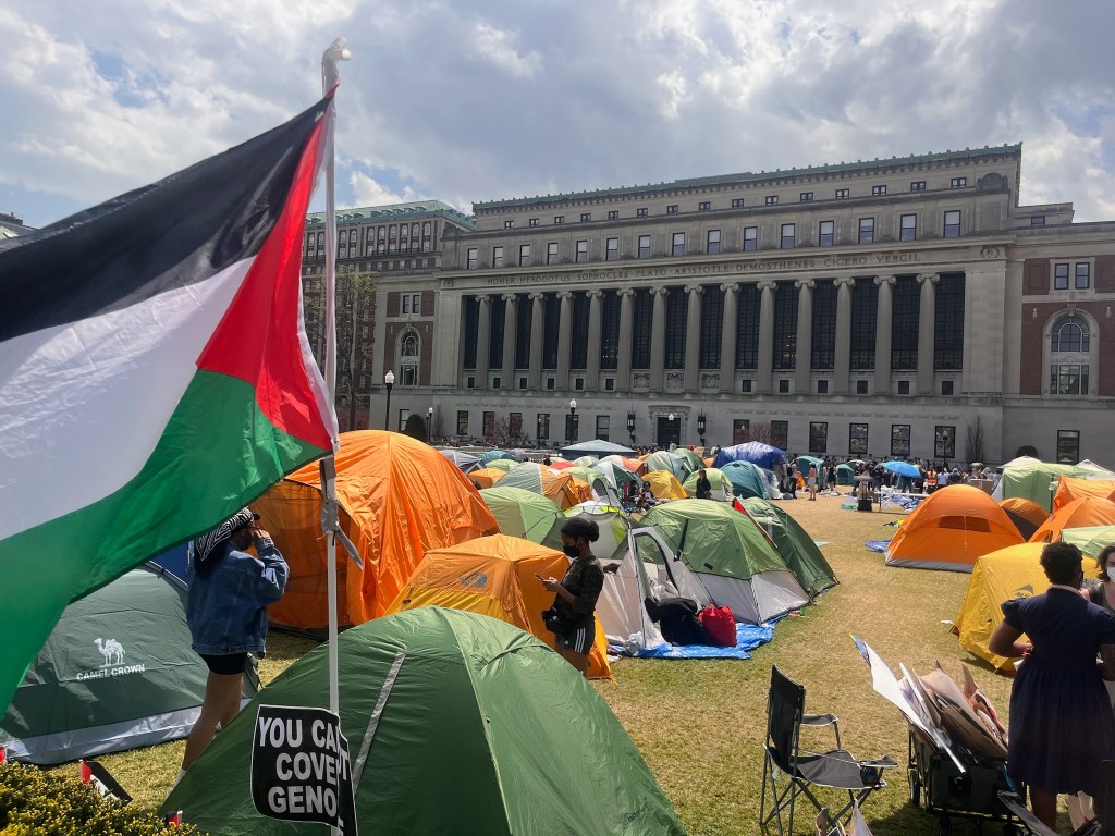 Tens and a Palestinian flag on Columbia lawn