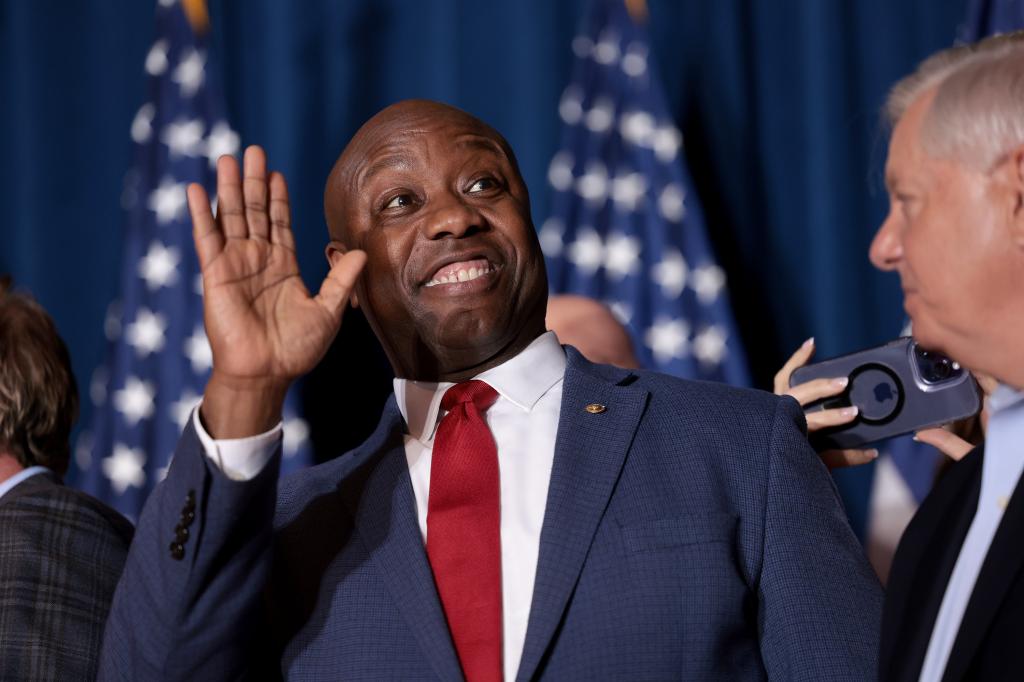 Sen. Tim Scott (R-SC) cheers on Republican presidential candidate and former President Donald Trump speaks during an election night watch party at the State Fairgrounds on February 24, 2024 in Columbia, South Carolina. 