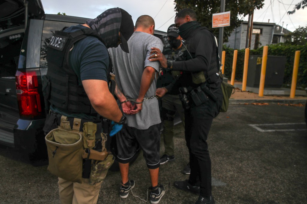 Immigration and Customs Enforcement agents apprehend an an illegal immigrant with criminal record, in an early morning raid at home on Thursday, Sept. 8, 2022 in Los Angeles, CA.