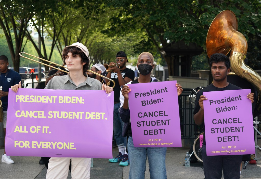 Student loan debt holders take part in a demonstration outside of the white house staff entrance to demand that President Biden cancel student loan debt in August on July 27, 2022 at the Executive Offices in Washington, DC.