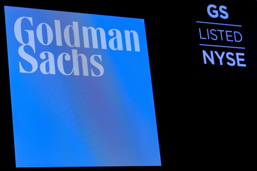 Goldman Sachs ticker symbol and logo being displayed on a screen on the trading floor of the New York Stock Exchange.