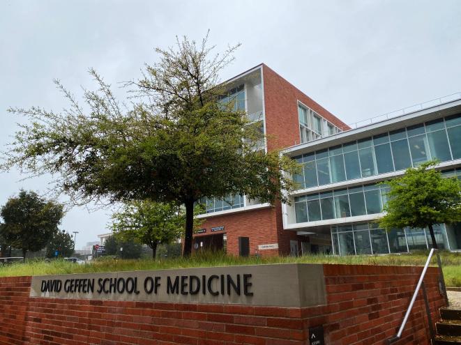 A sign for The David Geffen School of Medicine at UCLA, in front of a school building