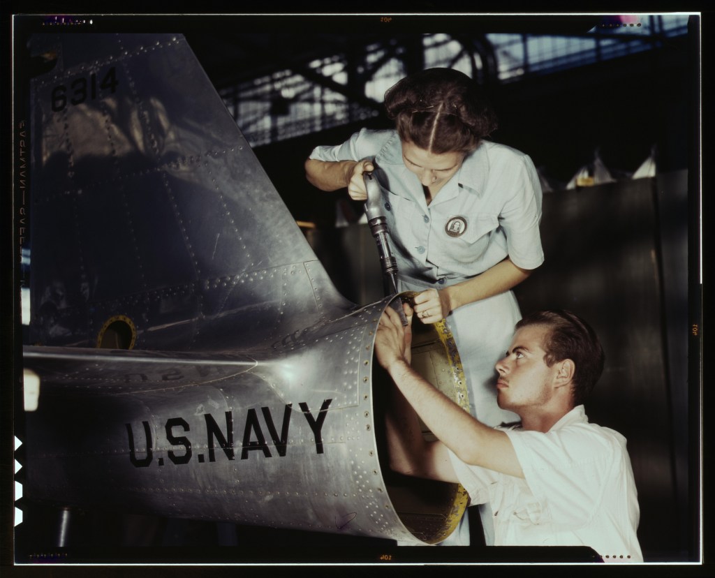 A woman riveting a plane fin