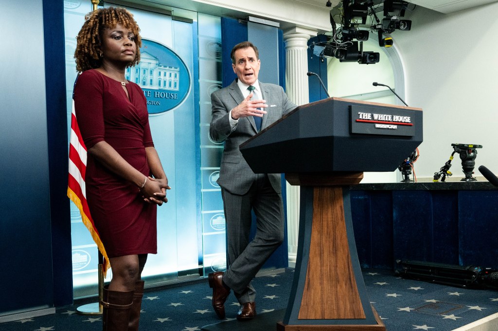 White House National Security Communications Advisor John Kirby (with White House Press Secretary Karine Jean-Pierre standing on the left) speaking at a press briefing in the White House Press Briefing Room in Washington, DC.