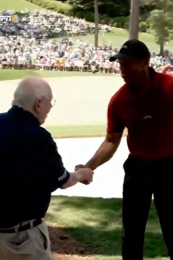 Tiger Woods and Verne Lundquist shake hands Sunday at the Masters.