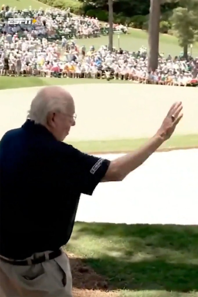 Verne Lundquist waves to Tiger Woods after the pair shook hands Sunday at the Masters.