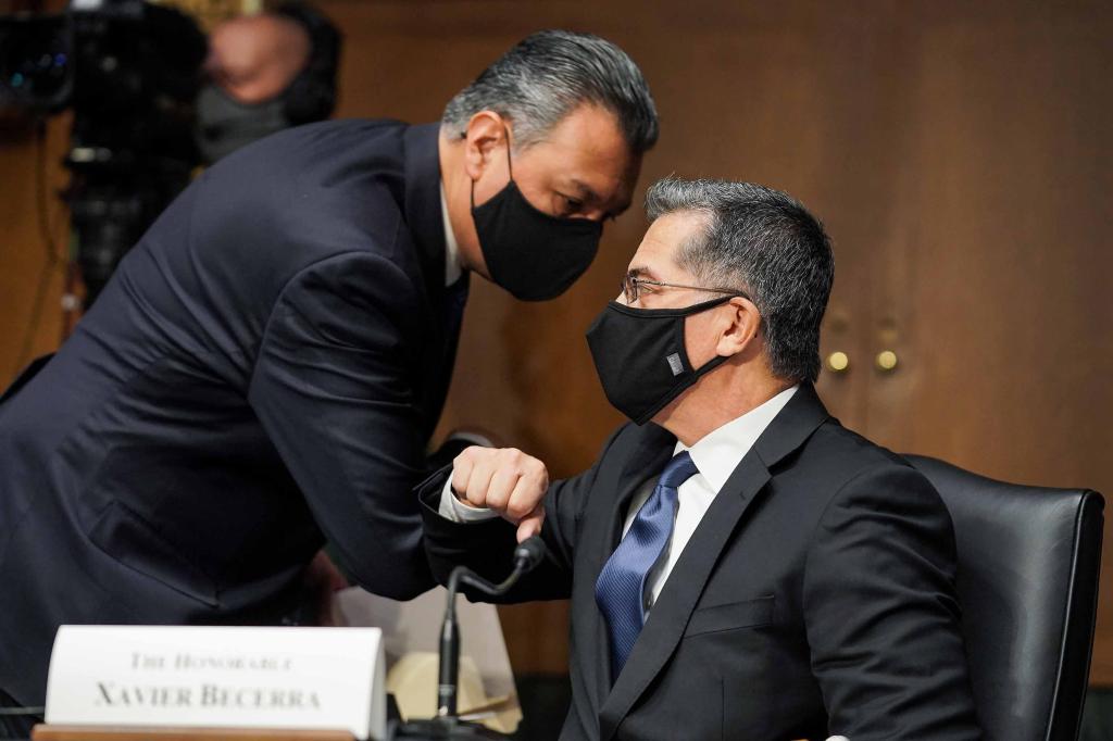 Xavier Becerra, nominee for Secretary of Health and Human Services, elbows bumps Sen. Alex Padilla (D-CA) during his Senate Finance Committee nomination hearing on February 24, 2021 in Washington, D.C.