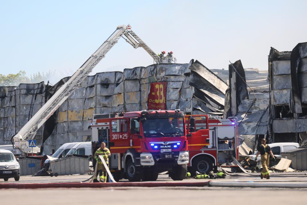 Firefighters work to extinguish a fire at a shopping complex in Warsaw, Poland