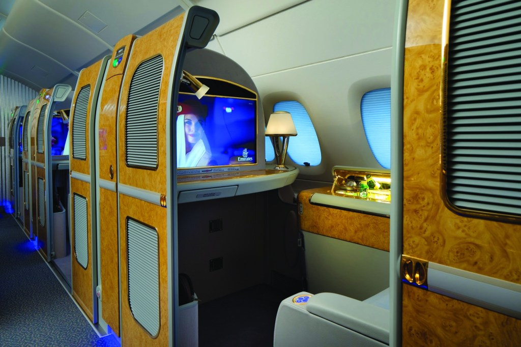 First class private suite in an Emirates Airlines airplane featuring a TV