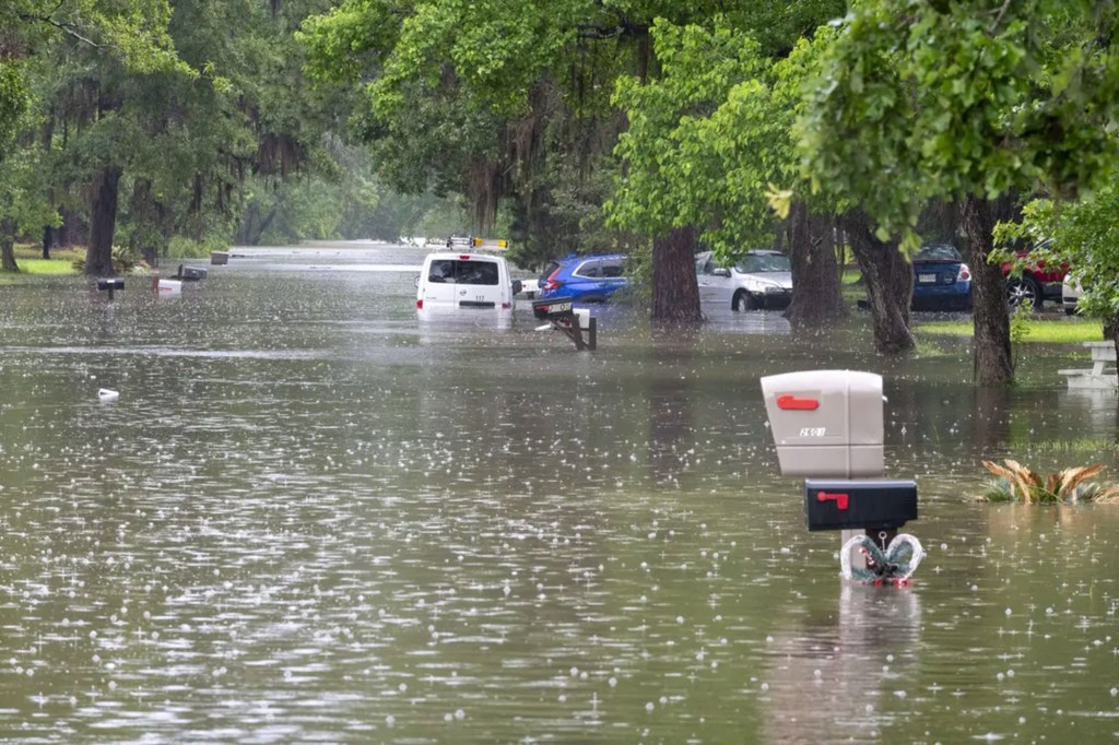 Cars navigating through a flooded street