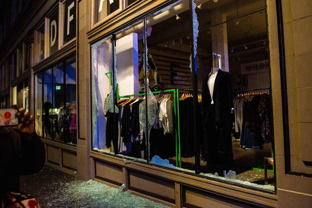 A clothing store is vandalized as police confront protesters in Portland, Oregon on November 4, 2020, during a demonstration called by the "Black Lives Matter" movement, a day after the US Presidential Election.