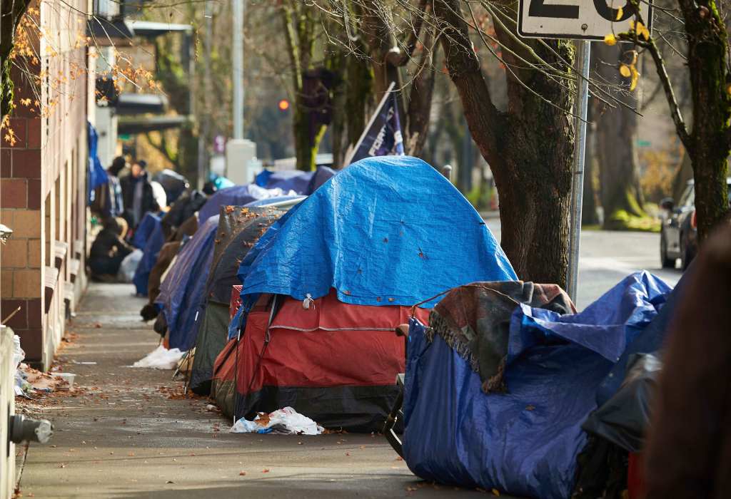 Tents line the sidewalk on Clay Street, Dec. 9, 2020, in Portland, Oregon.