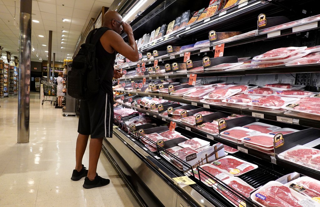 Shopper browsing products in a Miami grocery store on July 12, 2023, amid reports of lowest inflation in over two years.