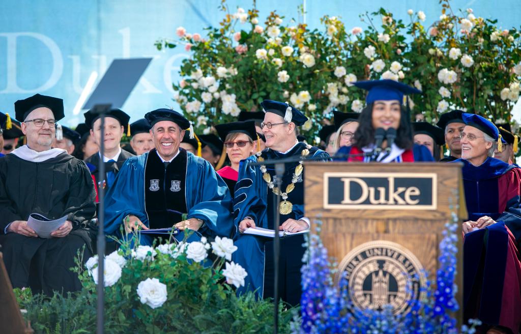 Jerry Seinfeld sits on the dais of the Duke commencement.