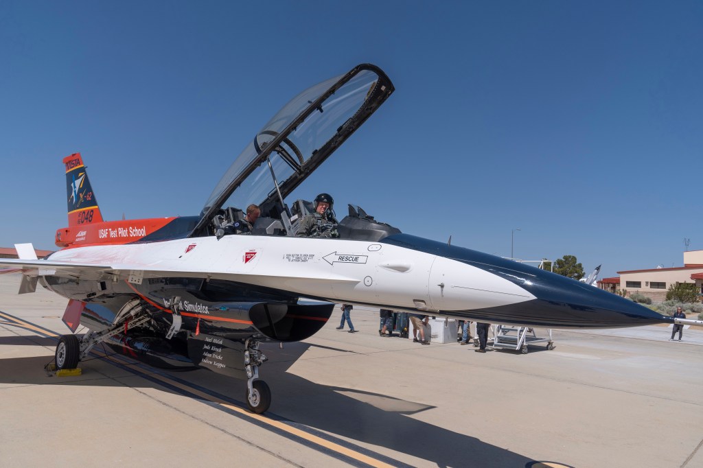 Air Force Secretary Frank Kendall sits in the front cockpit of an X-62A VISTA aircraft at Edwards Air Force