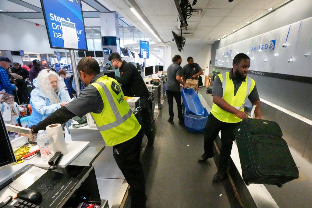 Passenger drop off their baggage.