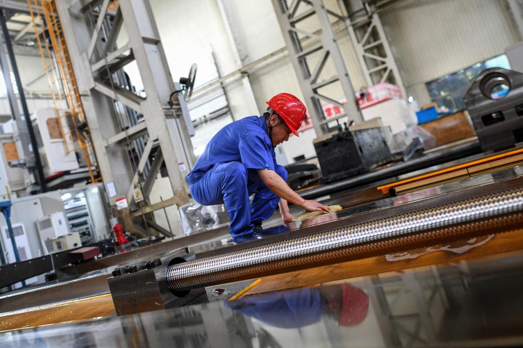 an employee working on a lathe machine production line