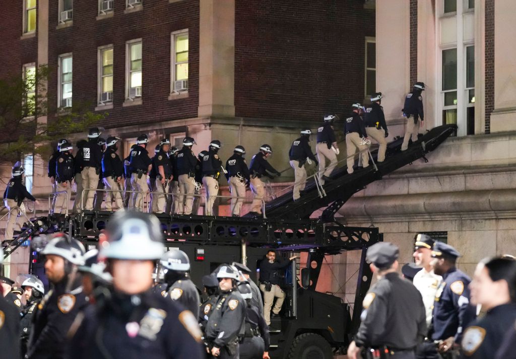 NYC police officers use a ramp on an armored vehicle to enter Hamilton Hall at Columbia University after pro-Palestinian protestors barricaded themselves in the building.