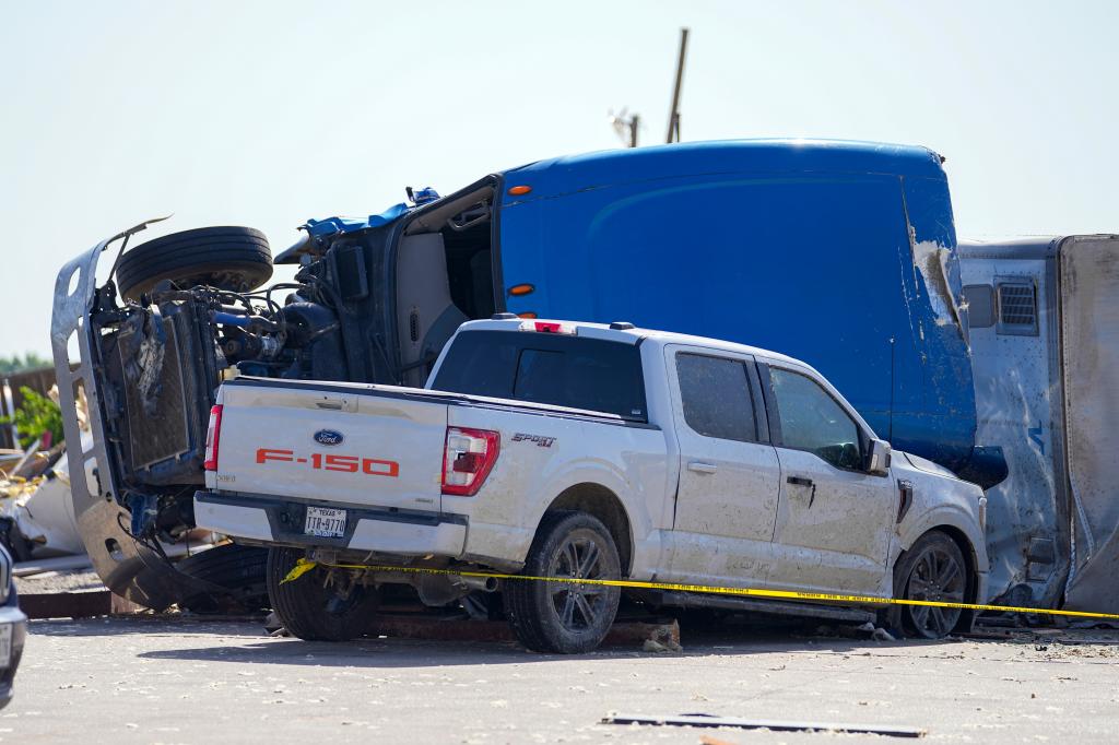 A pickup truck that crashed into a fallen tractor-trailer.