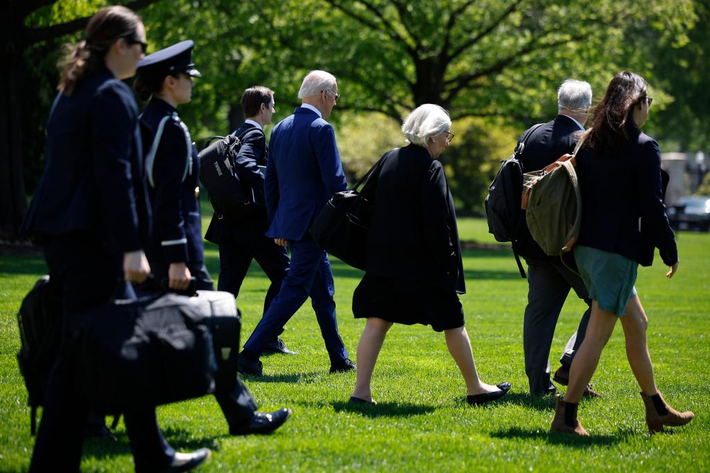 President Joe Biden (4th L) is accompanied by Deputy Chief of Staff Bruce Reed (3rd L), senior advisors Anita Dunn (5th L) and Mike Donilon (2nd R) as they depart the White House on April 23, 2024.