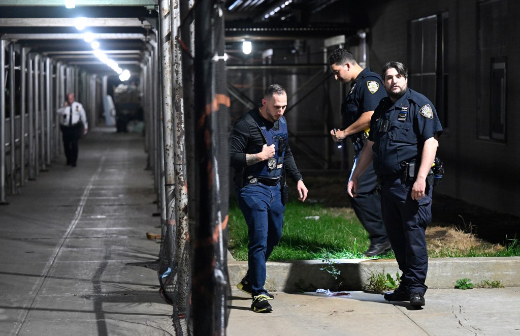 Police examine a blood stain found on the sidewalk outside the apartment where Rae’Lynn was killed in 2022