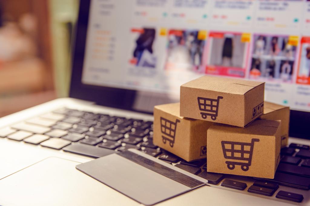 Shopping online concept - Shopping service on The online web. with payment by credit card and offers home delivery. parcel or Paper cartons with a shopping cart logo on a laptop keyboard