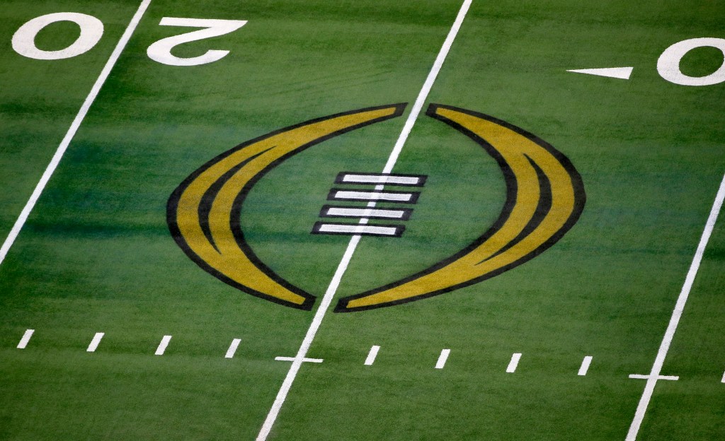 The College Football Playoff logo is shown on the field at AT&T Stadium before the Rose Bowl NCAA college football game between Notre Dame and Alabama in Arlington, Texas, Jan. 1, 2021. 