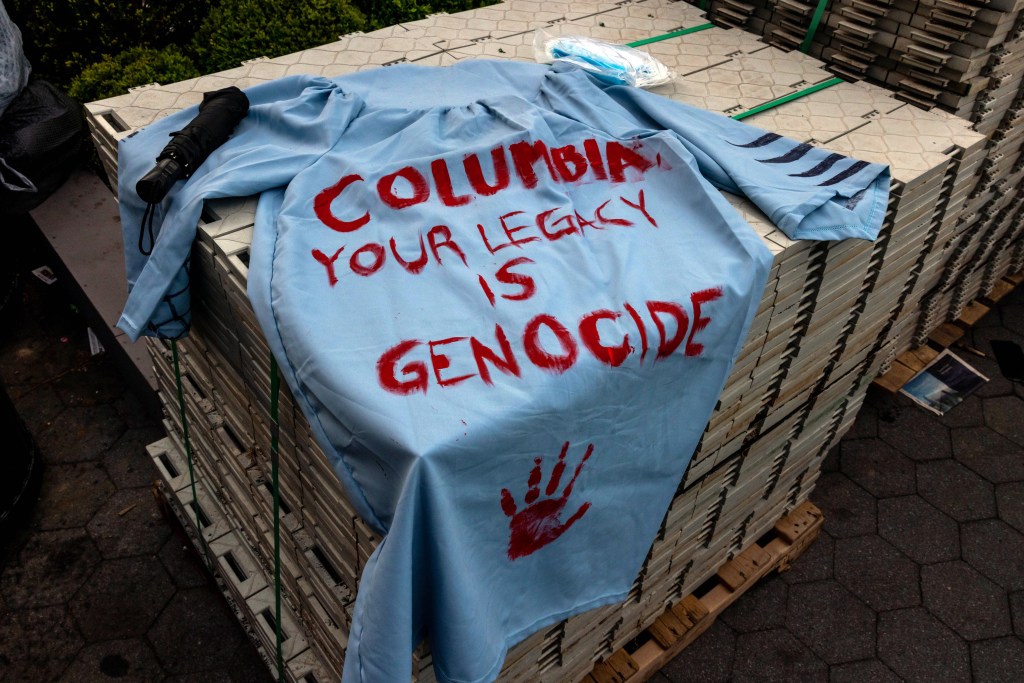 A graduation gown with a message from the protestors is left outside the encampment at Columbia University.